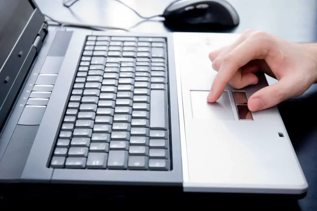 Male hand on notebook touchpad