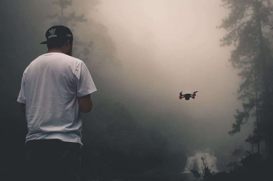 man with drone in fog