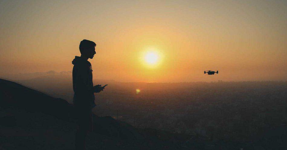 flying drone in sunset