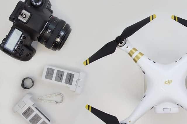 drone next to stand alone camera
