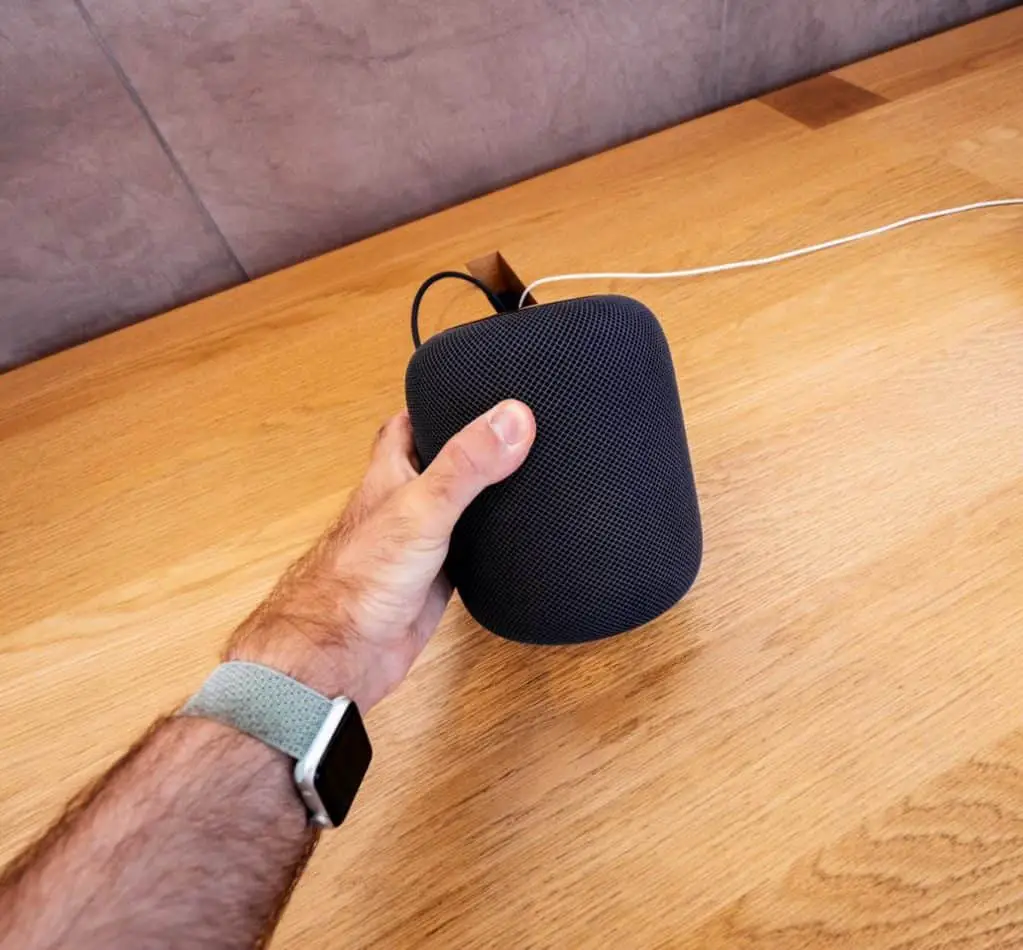 Man holding latest Apple HomePod