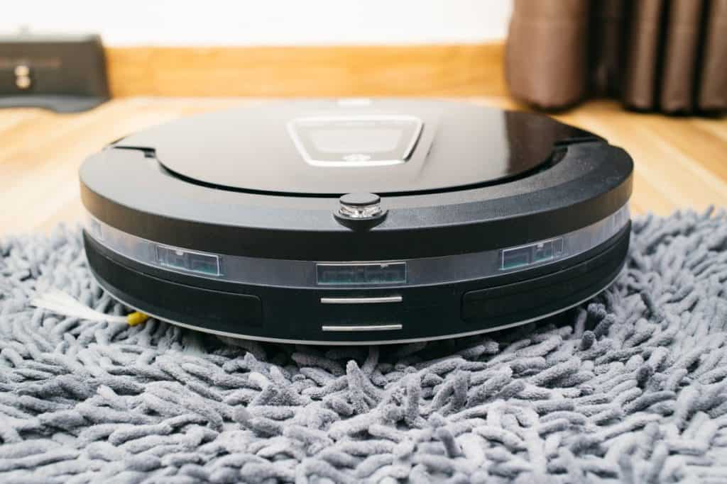 Robot vacuum cleaner on laminate wood and carpet