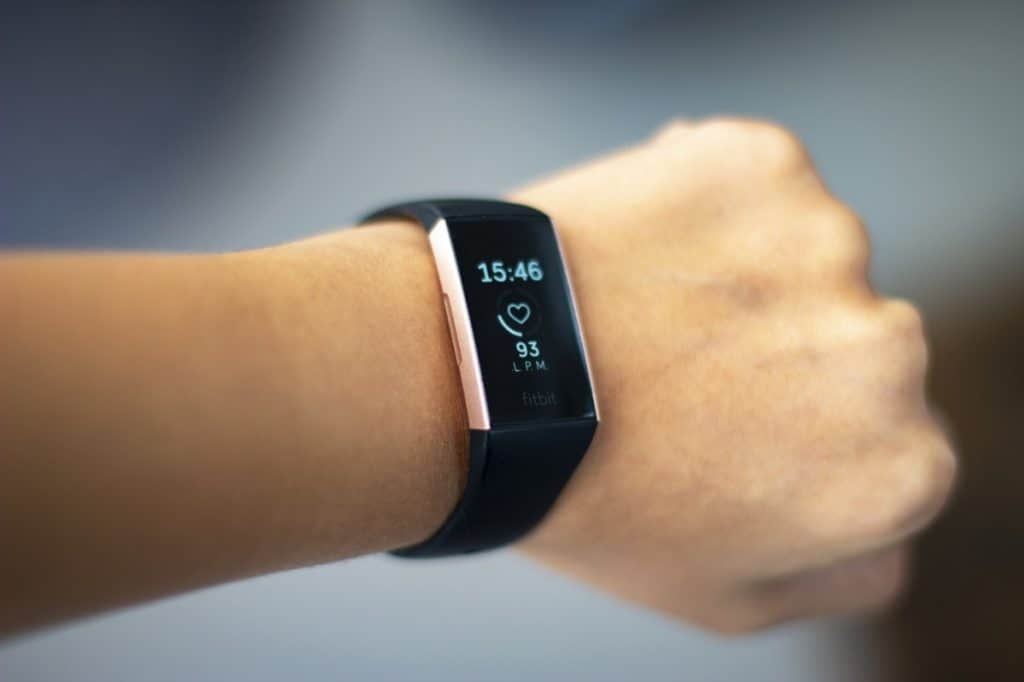 Woman monitoring her heart beat with a fitbit